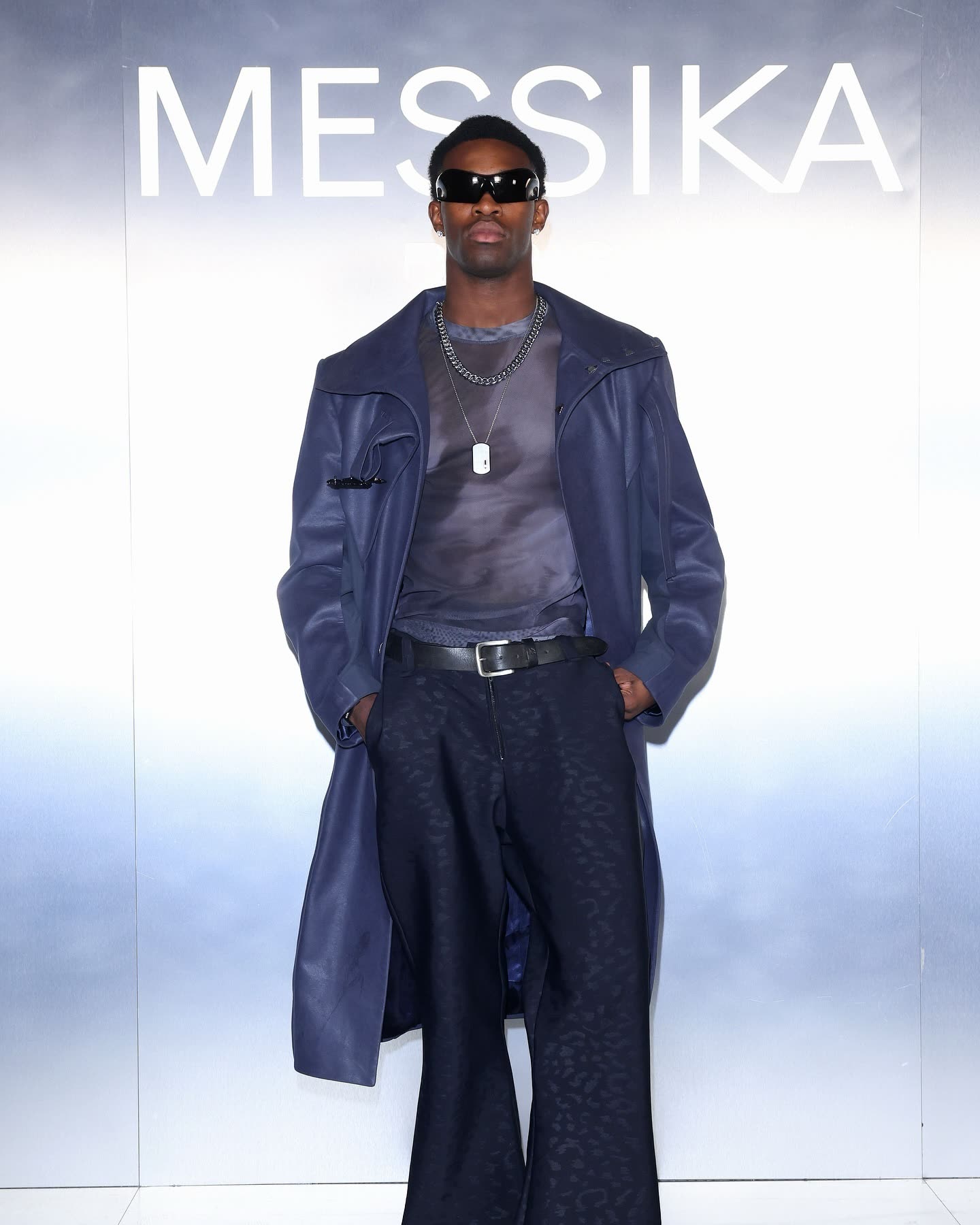 Talent in a navy leather coat at the Messika Paris Fashion Week wall